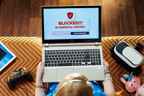 https://tower.10bestparentalcontrolapps.com/wp-content/uploads/2024/03/girl-in-blue-dress-sitting-on-couch-in-the-modern-living-room-having-access-restriction-by-parental-control-on-a-laptop-screen..jpg